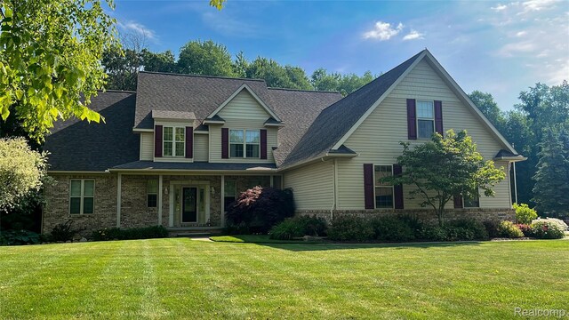 5580 Birch Ln, Davisburg, MI 48350 - view of front of home with a front yard, brick siding, and a shingled roof