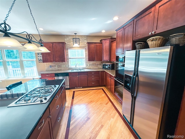 5580 Birch Ln, Davisburg, MI 48350 - kitchen with appliances with stainless steel finishes, light wood finished floors, backsplash, decorative light fixtures, and recessed lighting