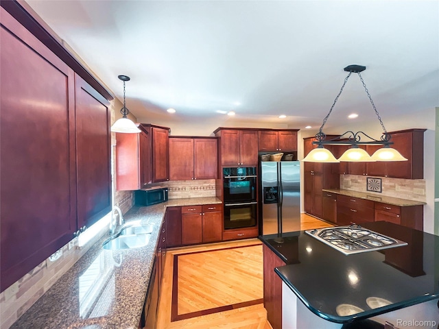 5580 Birch Ln, Davisburg, MI 48350 - kitchen with black appliances, tasteful backsplash, decorative light fixtures, recessed lighting, and dark stone counters