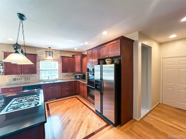 5580 Birch Ln, Davisburg, MI 48350 - kitchen with stainless steel appliances, light wood-type flooring, decorative backsplash, decorative light fixtures, and recessed lighting