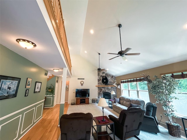 5580 Birch Ln, Davisburg, MI 48350 - living area with a ceiling fan, a fireplace, light wood-style floors, high vaulted ceiling, and wainscoting