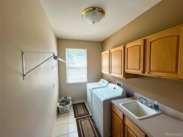 5580 Birch Ln, Davisburg, MI 48350 - laundry area featuring washer and dryer, cabinet space, and light tile patterned floors