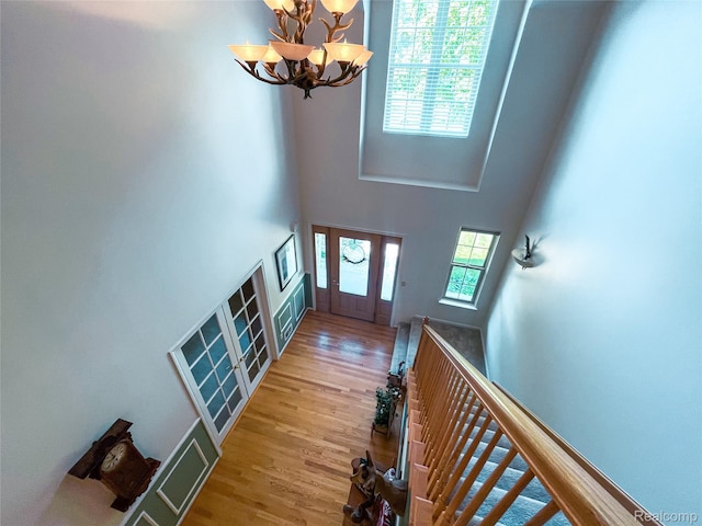 5580 Birch Ln, Davisburg, MI 48350 - foyer entrance with plenty of natural light, a chandelier, wood finished floors, and a towering ceiling