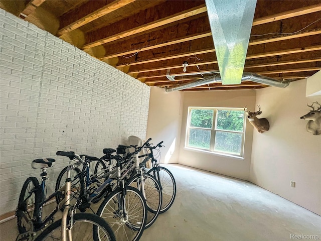 5580 Birch Ln, Davisburg, MI 48350 - miscellaneous room with brick wall and concrete floors