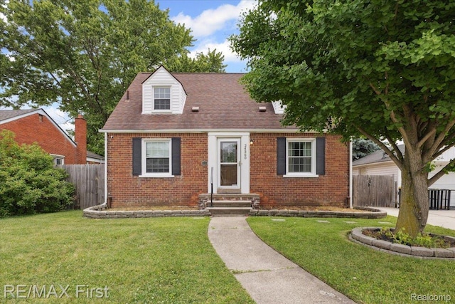24360 Grove Ave, Eastpointe, MI 48021 - cape cod house featuring brick siding and a shingled roof