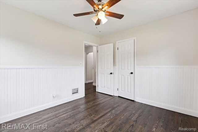 24360 Grove Ave, Eastpointe, MI 48021 - unfurnished bedroom with a wainscoted wall, wood finished floors, and a ceiling fan