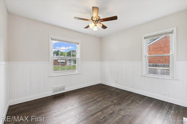 24360 Grove Ave, Eastpointe, MI 48021 - empty room featuring a wainscoted wall, wood finished floors, and a ceiling fan