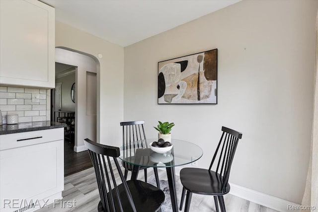 24360 Grove Ave, Eastpointe, MI 48021 - dining space with light wood-type flooring and arched walkways