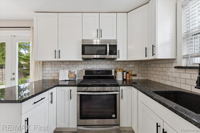 24360 Grove Ave, Eastpointe, MI 48021 - kitchen featuring stainless steel appliances, white cabinets, and healthy amount of natural light