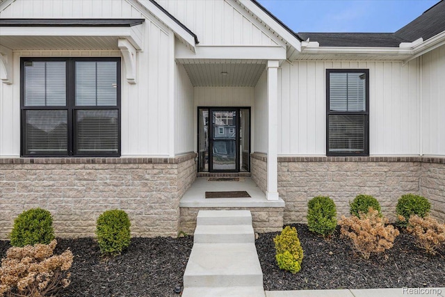 20848 Wexford Dr, Macomb, MI 48044 - view of exterior entry with stone siding and board and batten siding