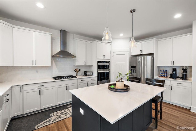 20848 Wexford Dr, Macomb, MI 48044 - kitchen with wall chimney exhaust hood, appliances with stainless steel finishes, backsplash, recessed lighting, and wood finished floors