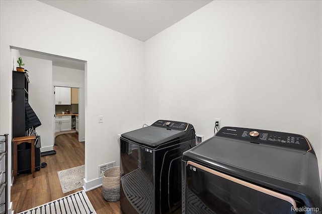 20848 Wexford Dr, Macomb, MI 48044 - laundry room with washer and dryer and wood finished floors