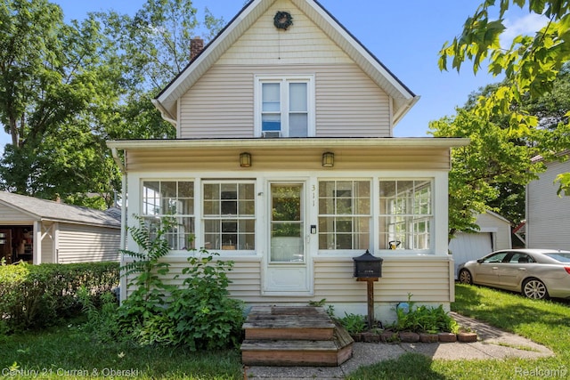 311 Yerkes St, Northville, MI 48167 - view of front of house featuring a sunroom