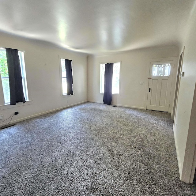 1418 Birney St, Saginaw, MI 48602 - unfurnished living room featuring carpet floors and baseboards