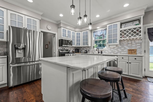 12449 Northway Pkwy, Freeland, MI 48623 - kitchen featuring stainless steel appliances, a kitchen bar, a kitchen island, light stone counters, and plenty of natural light