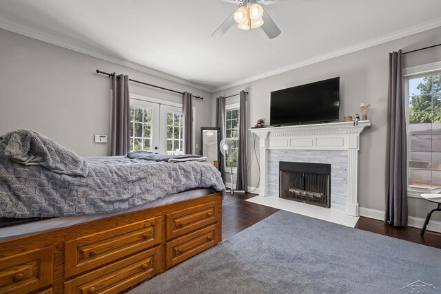 12449 Northway Pkwy, Freeland, MI 48623 - bedroom with multiple windows, dark wood-style floors, crown molding, a tiled fireplace, and a ceiling fan