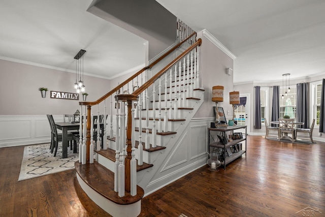 12449 Northway Pkwy, Freeland, MI 48623 - stairs with a decorative wall, crown molding, wood finished floors, a wainscoted wall, and a chandelier