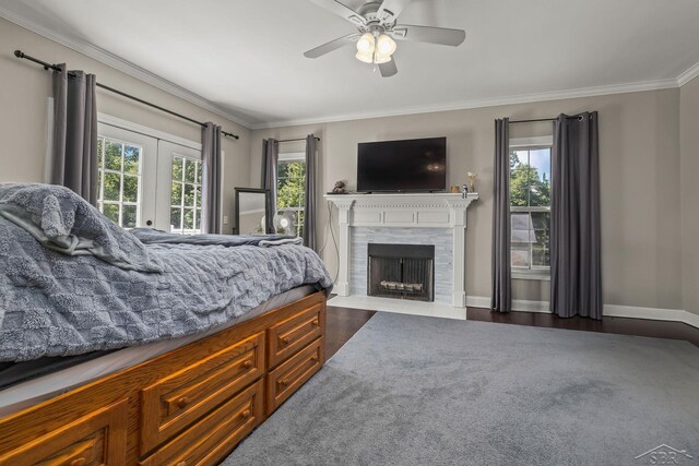 12449 Northway Pkwy, Freeland, MI 48623 - bedroom with ornamental molding, a fireplace with flush hearth, dark wood finished floors, and a ceiling fan