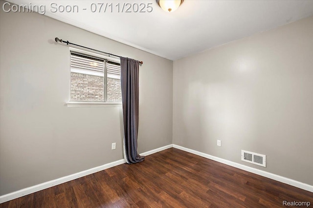 27043 Lorenz St, Madison Heights, MI 48071 - spare room with dark wood-style flooring and baseboards
