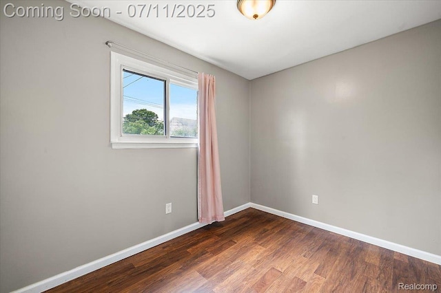 27043 Lorenz St, Madison Heights, MI 48071 - empty room with dark wood-style flooring and baseboards