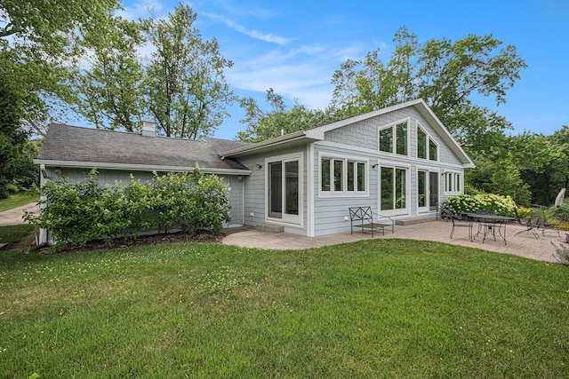 26794 Dutch Settlement St, Dowagiac, MI 49047 - back of property featuring a patio area, a chimney, a yard, and roof with shingles