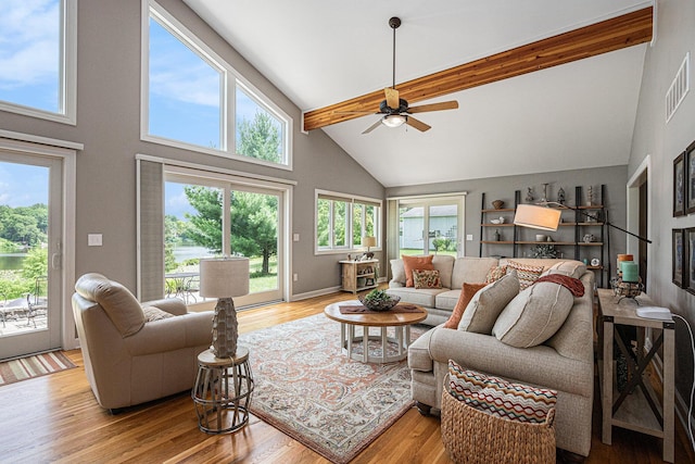 26794 Dutch Settlement St, Dowagiac, MI 49047 - living area featuring high vaulted ceiling, beam ceiling, a ceiling fan, and light wood-style floors