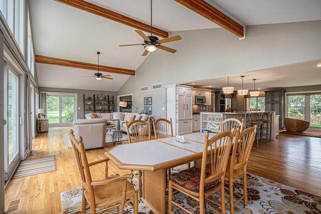 26794 Dutch Settlement St, Dowagiac, MI 49047 - dining area with light wood-style floors, ceiling fan, high vaulted ceiling, healthy amount of natural light, and beam ceiling