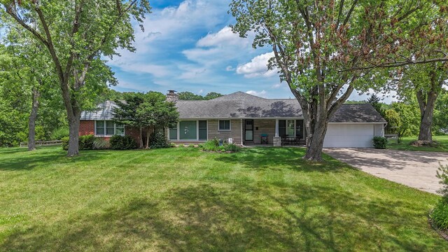 26794 Dutch Settlement St, Dowagiac, MI 49047 - ranch-style home featuring an attached garage, a chimney, concrete driveway, covered porch, and a front yard