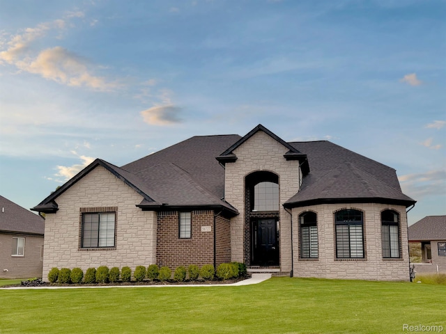 53650 Romeo Plank Rd, Macomb, MI 48042 - french provincial home featuring stone siding, a front lawn, and roof with shingles