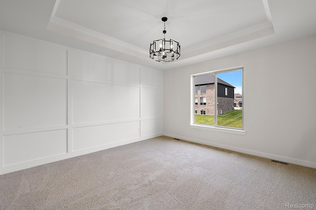 53650 Romeo Plank Rd, Macomb, MI 48042 - spare room with a tray ceiling, a chandelier, and carpet