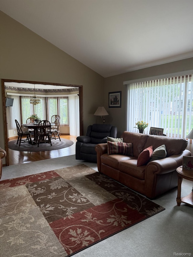 35851 Ireneus Dr, New Baltimore, MI 48047 - living room with carpet, lofted ceiling, and a chandelier