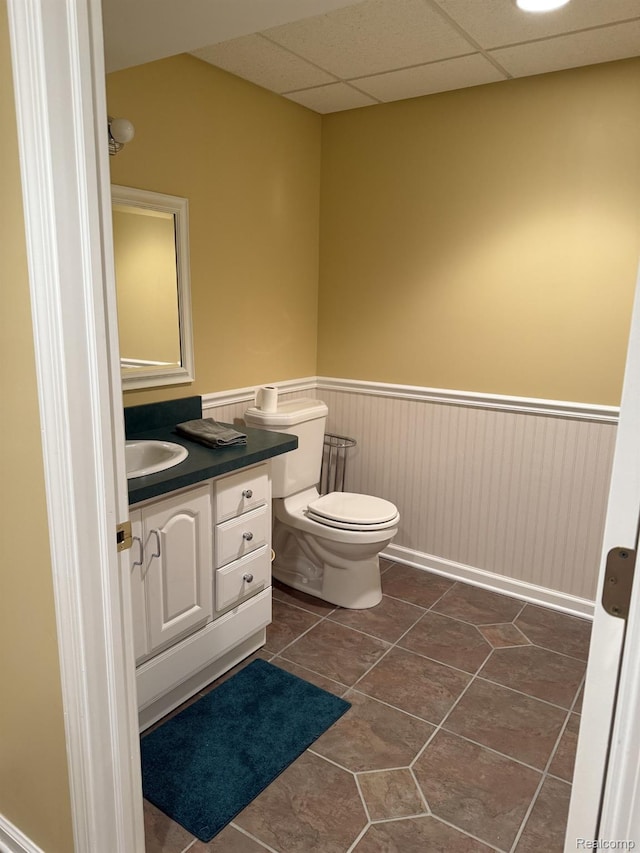 35851 Ireneus Dr, New Baltimore, MI 48047 - half bathroom featuring a wainscoted wall, vanity, tile patterned flooring, and a drop ceiling