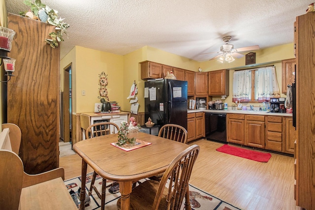 5100 Holton Duck Lake Rd, Twin Lake, MI 49457 - kitchen featuring black appliances, light countertops, brown cabinets, a ceiling fan, and light wood-style flooring