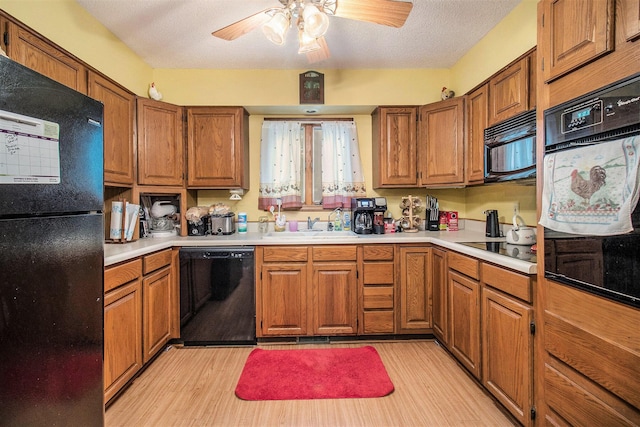 5100 Holton Duck Lake Rd, Twin Lake, MI 49457 - kitchen featuring black appliances, brown cabinets, light countertops, and a textured ceiling