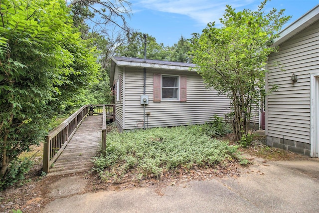 5100 Holton Duck Lake Rd, Twin Lake, MI 49457 - view of side of home with a wooden deck