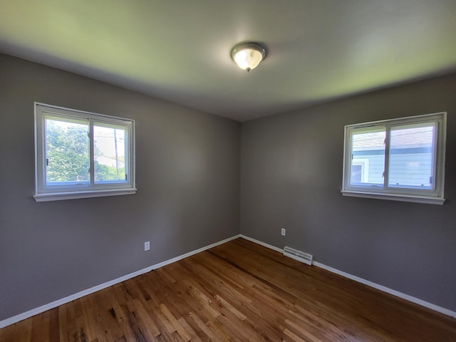 6163 Glenis St, Taylor, MI 48180 - empty room featuring plenty of natural light and dark wood-style floors