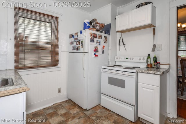 464 E Cambourne St, Ferndale, MI 48220 - kitchen featuring white appliances, white cabinets, light countertops, and stone finish flooring