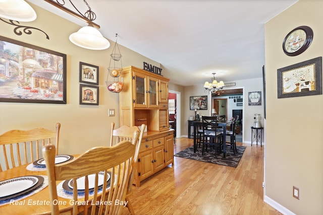 2165 Augsburg Dr, Saginaw, MI 48603 - dining area featuring a chandelier and light wood-style flooring