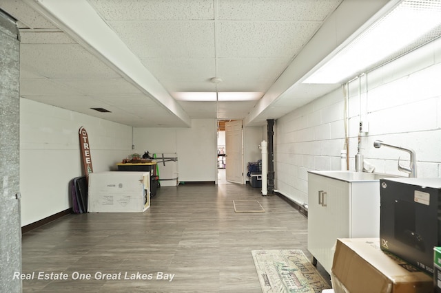 2165 Augsburg Dr, Saginaw, MI 48603 - washroom featuring concrete block wall and wood finished floors
