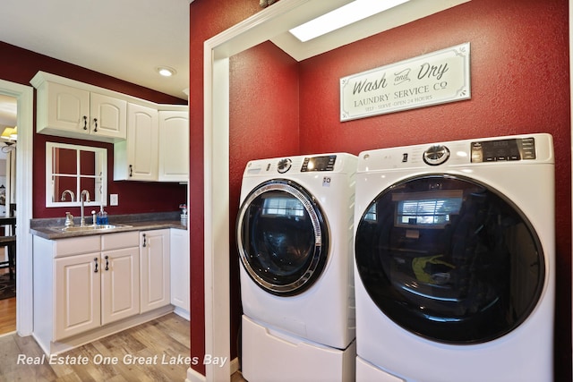 2165 Augsburg Dr, Saginaw, MI 48603 - washroom with washing machine and clothes dryer, light wood-style floors, bar with sink, recessed lighting, and a textured wall