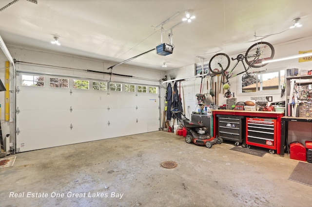 2165 Augsburg Dr, Saginaw, MI 48603 - garage with a workshop area and a garage door opener