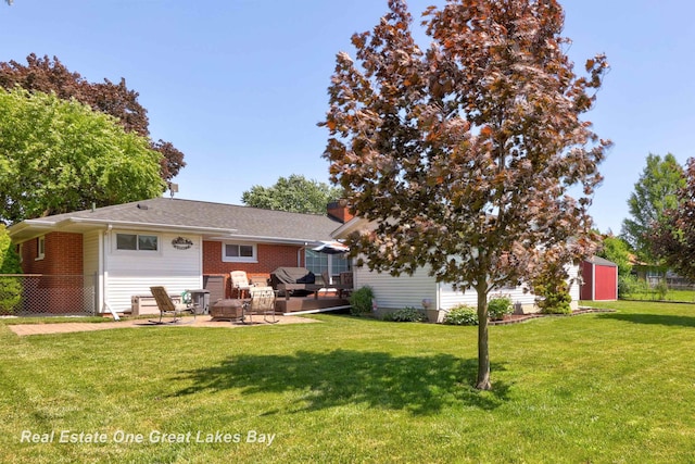 2165 Augsburg Dr, Saginaw, MI 48603 - rear view of property with a patio and brick siding