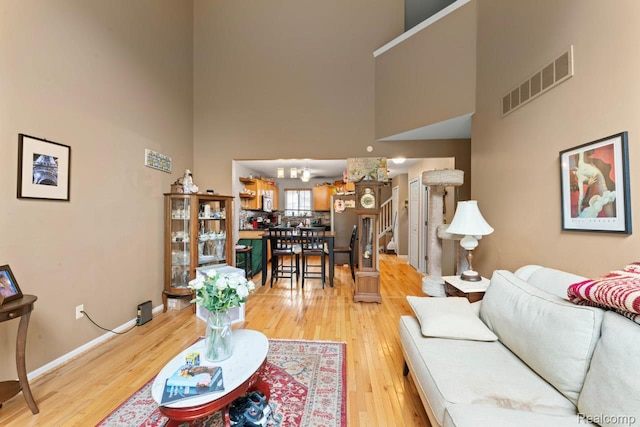 2255 Crystal Crossing Dr, Howell, MI 48843 - living area featuring a towering ceiling and light wood-type flooring
