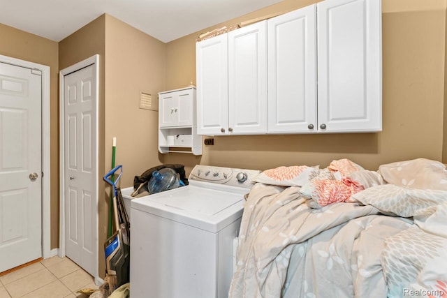 2255 Crystal Crossing Dr, Howell, MI 48843 - laundry area featuring washer / clothes dryer, cabinet space, and light tile patterned flooring