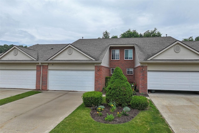 2255 Crystal Crossing Dr, Howell, MI 48843 - view of front of property featuring brick siding, concrete driveway, a shingled roof, and a garage