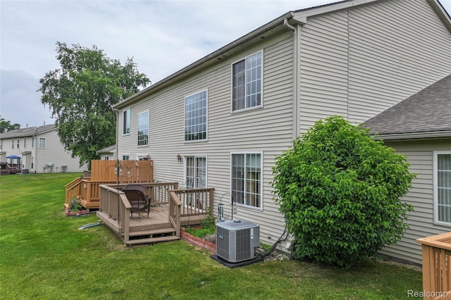 2255 Crystal Crossing Dr, Howell, MI 48843 - back of property with a wooden deck and a yard