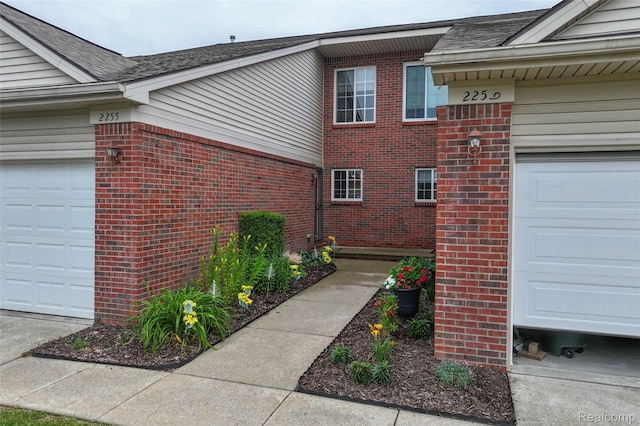 2255 Crystal Crossing Dr, Howell, MI 48843 - view of side of property with brick siding, roof with shingles, and an attached garage