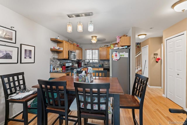 2255 Crystal Crossing Dr, Howell, MI 48843 - dining space with light wood-type flooring and baseboards
