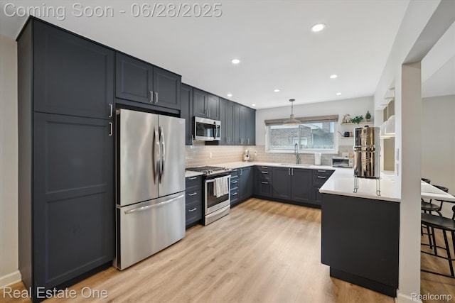 8409 Sandpiper St, Canton, MI 48187 - kitchen with stainless steel appliances, decorative backsplash, light wood-style floors, light countertops, and recessed lighting