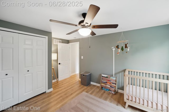 8409 Sandpiper St, Canton, MI 48187 - bedroom featuring wood finished floors, a closet, a nursery area, and a ceiling fan